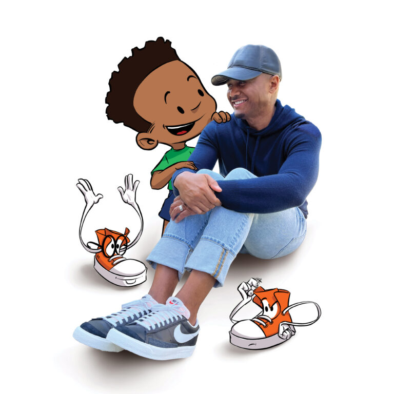 Author sits smiling, cartoon boy & animated sneakers look over his shoulder.